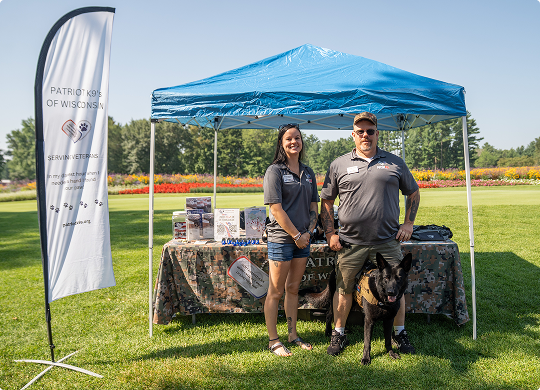 Two Sonnentag American Foundation team members at the Patriot K9s of Wisconsin booth supporting veteran and service member assistance programs.