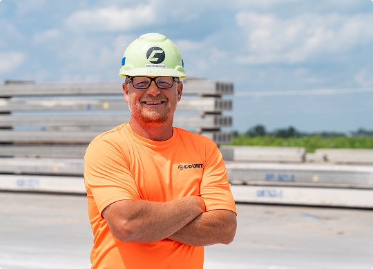 County Materials team member wearing safety gear at a precast concrete facility.