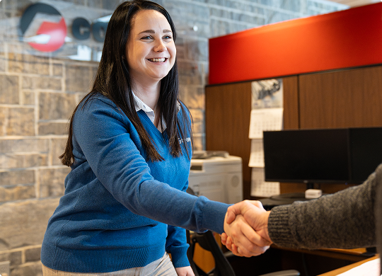 County Materials team member greeting a colleague in an office.